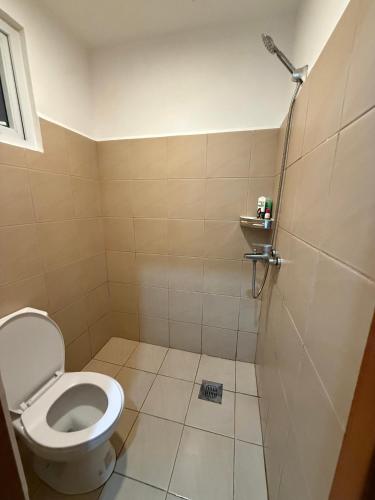 a bathroom with a toilet and a shower at E&J Solace Studio Mactan Bayanihan Flats 2 in Maribago
