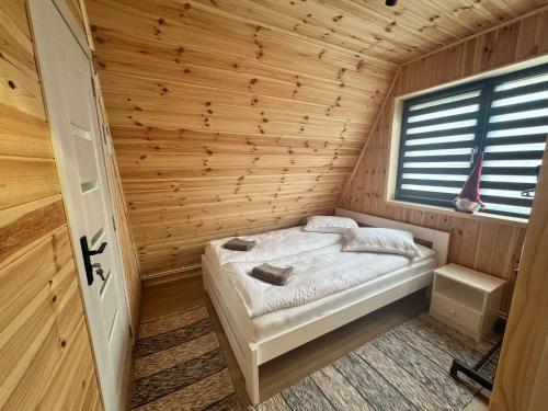 a bedroom with a bed in a wooden room at 3A-CHALET-LIBaN in Liban
