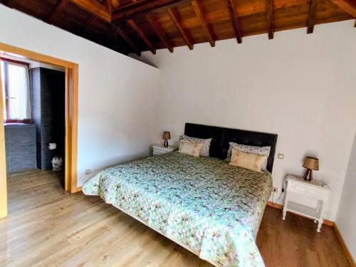 a bedroom with a bed and two night stands at Casa de Santa Luzia B in Caminha