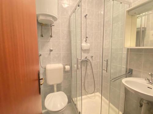 a bathroom with a shower and a toilet and a sink at Fran in Crikvenica