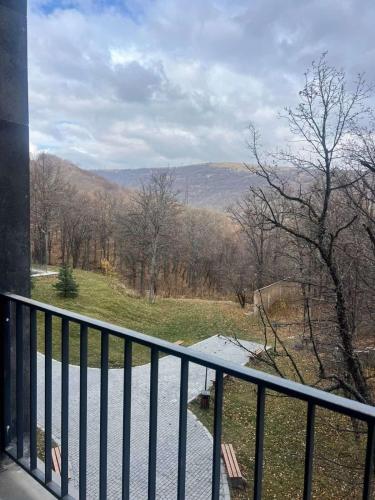 a balcony with a view of a field and mountains at Kechi House Jaklin in Tsaghkadzor