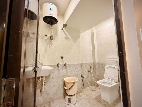 a bathroom with a toilet and a sink at Hotel Shree Darshan - Near Mahakal Mandir Ujjain in Ujjain