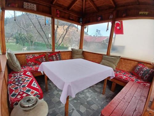 a dining room with a white table and chairs at Vinland Villa Atalar in Trabzon