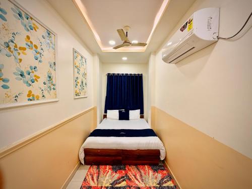 a small room with a bed and a window at Hotel Shree Darshan - Near Mahakal Mandir Ujjain in Ujjain