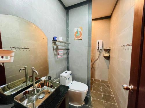 a bathroom with a sink and a toilet at Green Island Bungalows in Kampot
