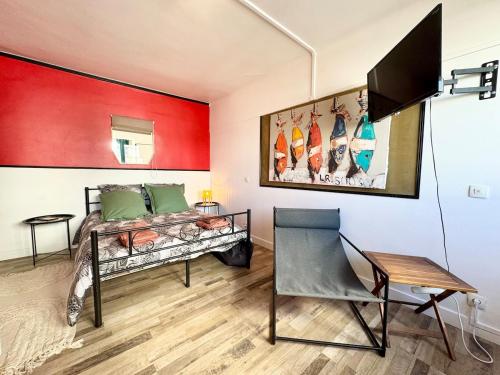 a bedroom with a bed and a red wall at Chez Mamie Cloclo in Calais