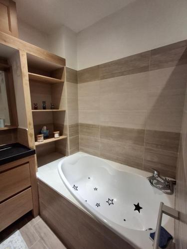 a bathroom with a bath tub with stars on it at La maison de Lau in Salies-de-Béarn