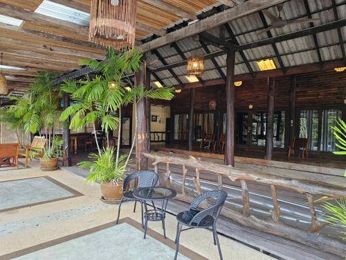 a patio with chairs and tables in a building at The Mangrove Hideaway Kohchang in Ko Chang