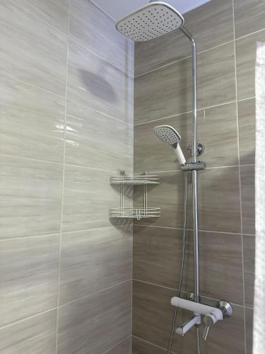 a shower with a shower head in a bathroom at Stop Time in Slavske