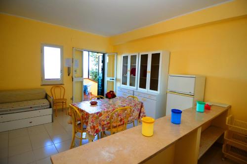 a kitchen with a table and a dining room at Appartamenti Del Sole in Tropea
