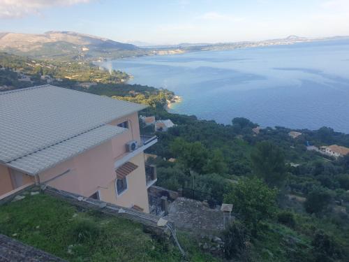 a house with a view of the water at Bay View Suites & Apartments in Marathias