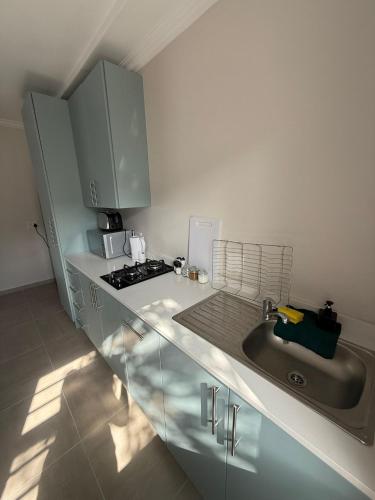 a kitchen with a sink and a stove at Ocean Whisper in Plettenberg Bay