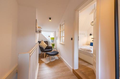 a hallway with a stairway leading to a bedroom at K94 Fischerhaus in Greetsiel