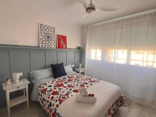 a bedroom with a bed and a window at Puertas del Mar 1 in Puerto Real
