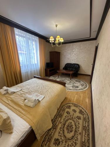 a bedroom with a large bed and a window at Hotel&Restaurant SENATOR in Truskavets