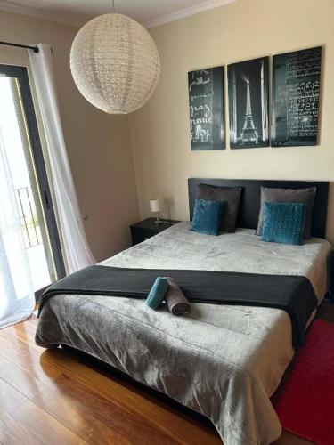 a bedroom with a large bed with blue pillows at Sea View Andrade 3 Bedroom House in Gaula
