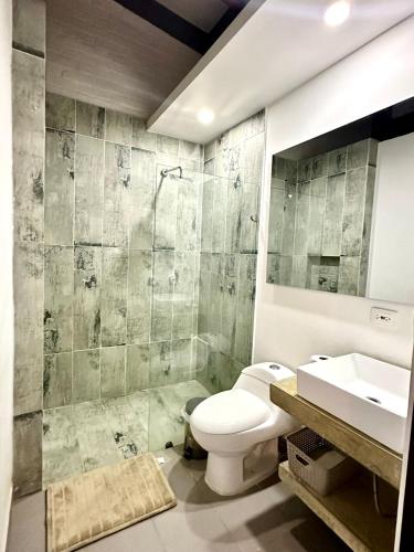 a bathroom with a toilet and a sink at Casa Boutique Calima in Restrepo