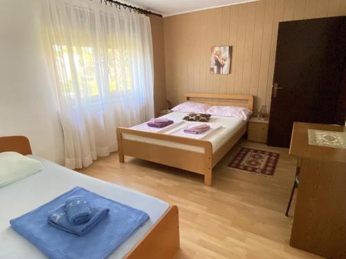 a small bedroom with two beds and a window at Fran in Crikvenica