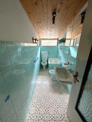 a bathroom with a toilet and a sink and a tub at Mansarda Belvedere in Margno