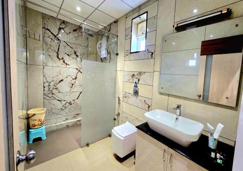 a bathroom with a sink and a toilet at Hotel Heritage Inn in Balasore