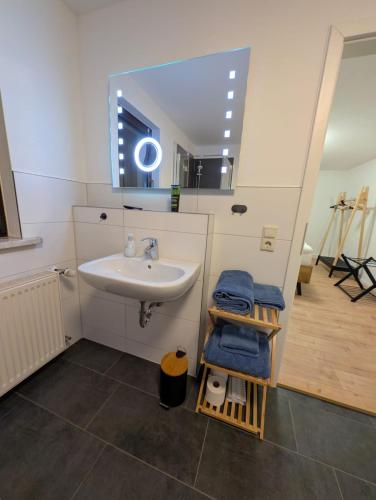 a bathroom with a sink and a mirror at Ferienwohnung Waldenburg Sachsen II in Waldenburg