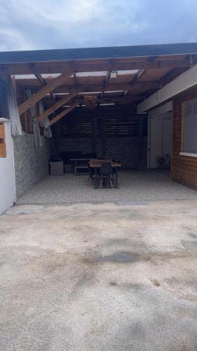 an outdoor patio with a table and a table at Le repaire de la mare in Salazie