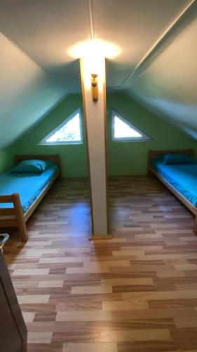 a room with two beds and a light on the ceiling at Cabana Iubirii in Ranca