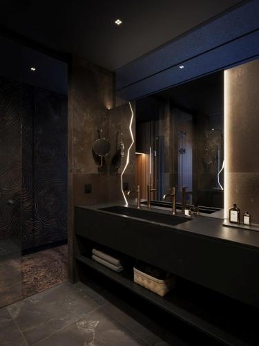 a bathroom with a sink and a large mirror at Arcora Boutique Hotel & Villas in Muonio