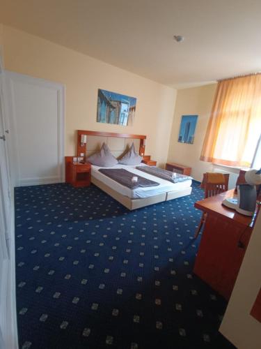 a bedroom with a large bed and a desk at ZM 22, King Room doubleBed in Leverkusen