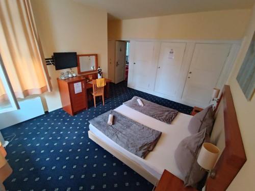 a hotel room with two beds and a desk at ZM 22, King Room doubleBed in Leverkusen