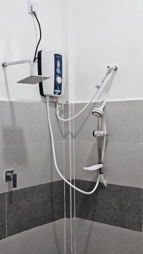 a bathroom with an electronic device on a wall at Shan Villa Dambulla in Dambulla