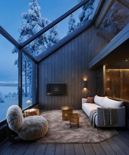 a living room with a couch and a tv at Arcora Boutique Hotel & Villas in Muonio