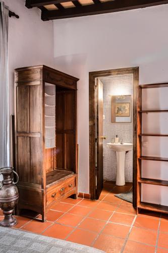 a bathroom with a wooden cabinet and a sink at La Posada de Zepeda in Jerez de la Frontera