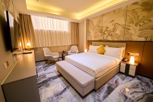 a hotel room with a large bed in a room at Dembesh Hotel Juba in Juba