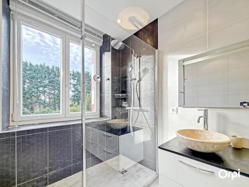a bathroom with a sink and a glass shower at REF 495 Quéven type 7 manor house in Quéven