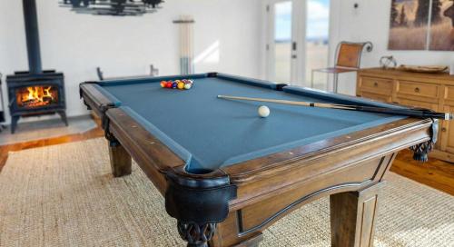 a pool table in a living room with a pool ball at Luxury Off-Grid Cabin with Stargazing Deck & Views in Fairplay