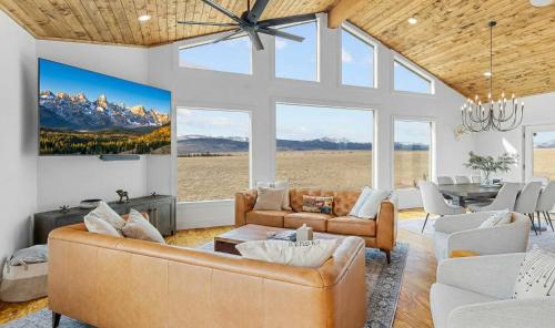 a living room with couches and a dining room at Luxury Off-Grid Cabin with Stargazing Deck & Views in Fairplay