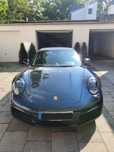 a blue car parked in front of a garage at Hotel Freiheit in Cologne