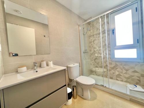 a bathroom with a toilet and a sink and a shower at CJ186 - Ciudad Jardin I, Prime - ServHouse in El Borseral