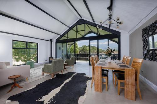 a living room with a dining room table and chairs at De Hoop Farm - Mountain View in Breërivier