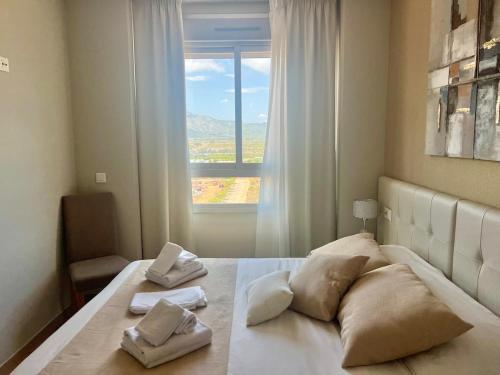 a bedroom with a large bed with a window at CJ186 - Ciudad Jardin I, Prime - ServHouse in El Borseral