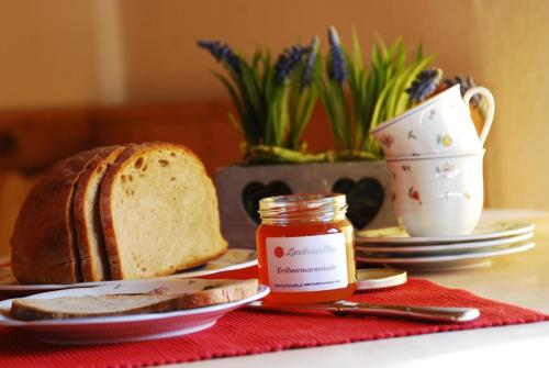 a table with a loaf of bread and a jar of jam at Landhaus Elke in Reith bei Seefeld