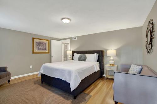 a bedroom with a large bed and a couch at Oglethorpe Manor Garden Level in Savannah