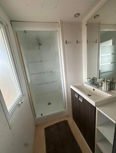 a bathroom with a shower and a sink at Sunset Lagoon House in Lagoa