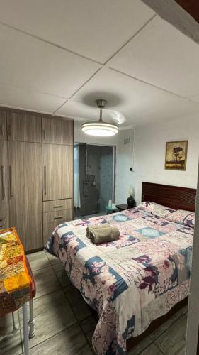 a bedroom with a large bed in a room at Ahava Accommodation in Scottburgh