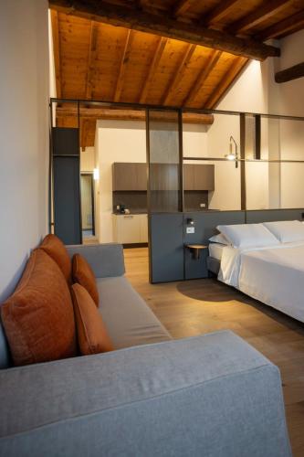 a bedroom with a bed and a couch in it at Ca Moroni Collection in Bergamo