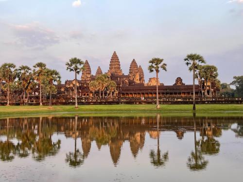 a view of a temple with a reflection in a lake at Angkor Nature Voyages in Phumi Ta Phul