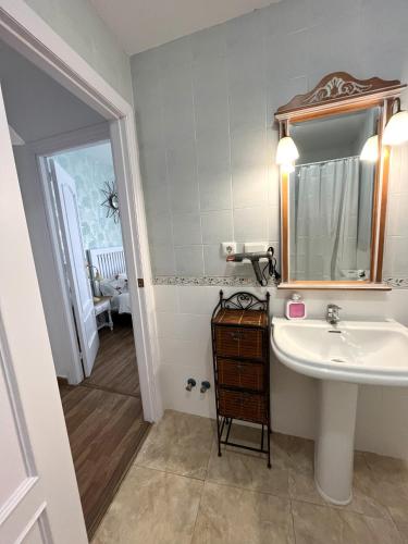 a bathroom with a sink and a mirror at The Llanete Collection 01 in Martos