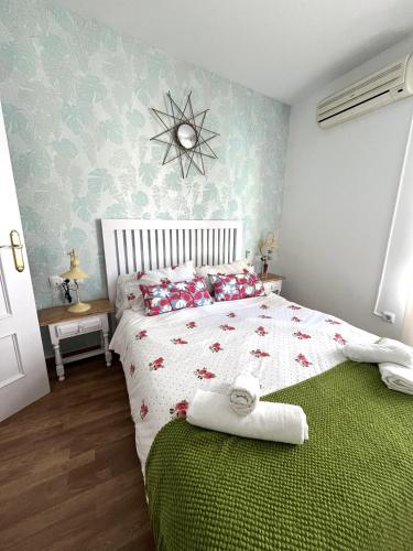 a bedroom with a white bed with red pillows at The Llanete Collection 01 in Martos