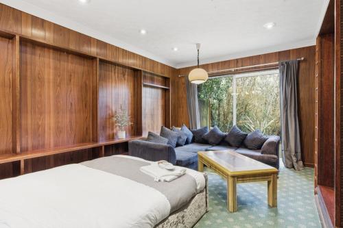a bedroom with a bed and a couch at Luxury 5 Bedroom with Pool & Games Room in Potter Street